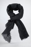 A black, lightweight scarf is artfully tied in a loose knot. The all-weather Color-POP Scarf from looselyboho has a slightly crinkled texture and frayed edges, giving it a casual yet stylish appearance. The background is plain and light, highlighting the scarf's details, making it a perfect addition to Wjackets.